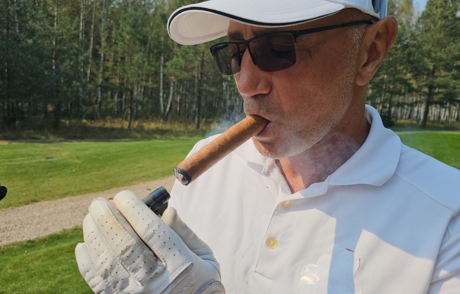 Golfer enjoying a cigar on the course