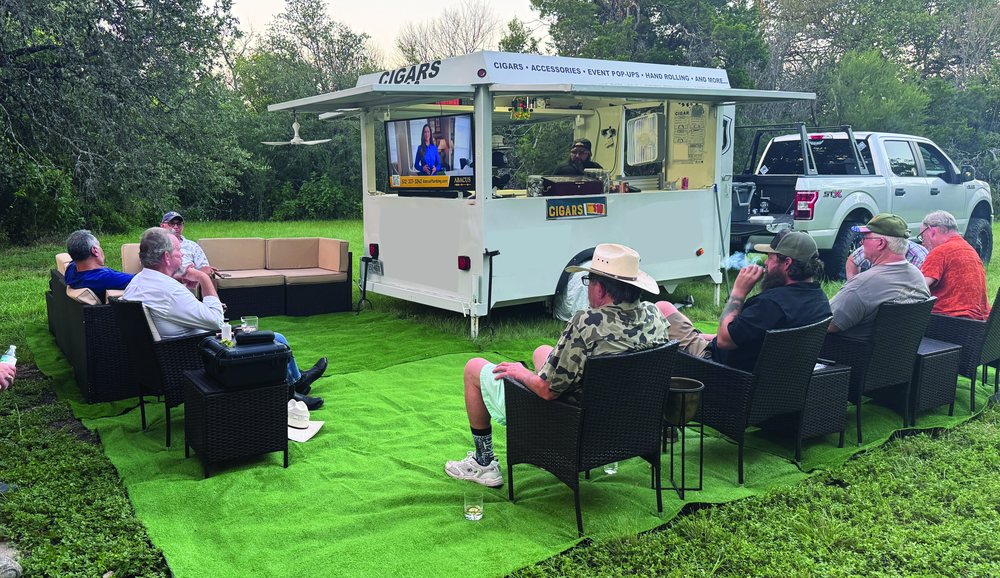 Cut & Light mobile cigar lounge trailer with outdoor seating and guests